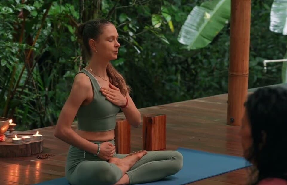 Candlelit singing bowl on a cushion during a guided sound healing session